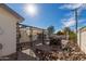 Sun-drenched backyard with patio, pergola, and woodpile. Ideal for outdoor living at 2518 E Campbell Ave, Phoenix, AZ 85016