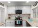 Updated kitchen with white cabinets, granite counters, and stainless steel appliances at 2518 E Campbell Ave, Phoenix, AZ 85016