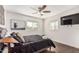 Spacious bedroom featuring a large bed, wood flooring, and a wall-mounted TV at 2518 E Campbell Ave, Phoenix, AZ 85016