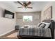 Cozy bedroom with ceiling fan, hardwood floors and a TV at 2518 E Campbell Ave, Phoenix, AZ 85016