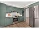 Modern kitchen with stainless steel appliances and green cabinets at 103 E Palm Ln # A, Phoenix, AZ 85004