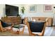 Living room with mid-century modern furniture and large TV at 103 E Palm Ln # A, Phoenix, AZ 85004
