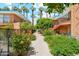 Landscaped walkway between condo buildings with lush greenery at 103 E Palm Ln # A, Phoenix, AZ 85004