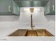 Modern kitchen sink with gold faucet and white countertop at 103 E Palm Ln # A, Phoenix, AZ 85004