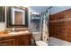 Bathroom with tile shower/tub combo and wood vanity at 27789 N 129Th Ln, Peoria, AZ 85383