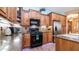 Spacious kitchen with dark wood cabinets, granite countertops, and stainless steel appliances at 27789 N 129Th Ln, Peoria, AZ 85383