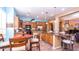 Kitchen features an island with seating and dark wood cabinets at 27789 N 129Th Ln, Peoria, AZ 85383