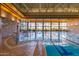 Indoor lap pool with large windows and stone accents at 27789 N 129Th Ln, Peoria, AZ 85383