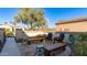 Inviting patio with wooden furniture and beautiful landscaping at 27789 N 129Th Ln, Peoria, AZ 85383