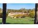 Serene golf course view with palm trees and lush landscaping at 27789 N 129Th Ln, Peoria, AZ 85383