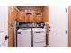 Laundry room with washer, dryer, and ample cabinet storage at 27789 N 129Th Ln, Peoria, AZ 85383