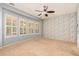 Bedroom with neutral carpeting, window shutters, and accent wall at 27789 N 129Th Ln, Peoria, AZ 85383