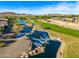 Serene lakefront view with lush landscaping and homes nearby at 27789 N 129Th Ln, Peoria, AZ 85383