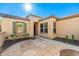 Front entry of a tan stucco house with a flagstone patio and desert landscaping at 27789 N 129Th Ln, Peoria, AZ 85383