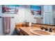 Bathroom with double sinks and terracotta tile accents at 27789 N 129Th Ln, Peoria, AZ 85383