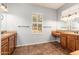 Double vanity bathroom with wood cabinets, tile flooring, and a large window at 27789 N 129Th Ln, Peoria, AZ 85383