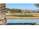 Peaceful golf course with a pond reflecting the scenery at 27789 N 129Th Ln, Peoria, AZ 85383
