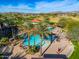 Resort-style pool with multiple lounge chairs and palm trees at 27789 N 129Th Ln, Peoria, AZ 85383