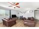 Living room with brown leather couches and wood-look floors at 2132 W Glenrosa Ave # 81D, Phoenix, AZ 85015