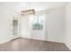 Bright dining room features wood-look tile floors, window blinds, and a modern chandelier at 905 S Canal Dr # 17, Chandler, AZ 85225