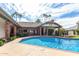Inviting kidney-shaped pool with brick coping, surrounded by lush landscaping at 2166 E Caroline Ln, Tempe, AZ 85284