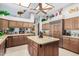 Kitchen boasts an island, granite countertops and ample cabinet space at 2166 E Caroline Ln, Tempe, AZ 85284