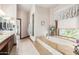 Elegant bathroom featuring a large soaking tub and granite vanity at 2166 E Caroline Ln, Tempe, AZ 85284