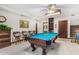 Basement game room with pool table, seating, and built-in shelving at 2166 E Caroline Ln, Tempe, AZ 85284