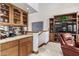 Wet bar with wood cabinetry, granite countertop and TV at 2166 E Caroline Ln, Tempe, AZ 85284