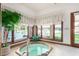 Indoor hot tub with large windows overlooking the pool at 2166 E Caroline Ln, Tempe, AZ 85284