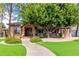 Brick house with a large tree, walkway, and manicured lawn at 2166 E Caroline Ln, Tempe, AZ 85284