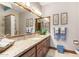 Bathroom boasts granite countertop, double sinks, and wood cabinets at 2166 E Caroline Ln, Tempe, AZ 85284