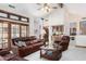 Spacious living room featuring leather furniture and access to a sunroom at 2166 E Caroline Ln, Tempe, AZ 85284