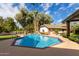 Octagon pool with brick coping and rock waterfall feature at 2166 E Caroline Ln, Tempe, AZ 85284