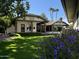 Landscaped backyard with lush lawn, mature trees and home at 2166 E Caroline Ln, Tempe, AZ 85284