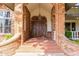 Inviting front entrance with brick columns and a double wooden door at 2166 E Caroline Ln, Tempe, AZ 85284