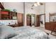 Spacious bedroom with ensuite bathroom and wood furniture at 2166 E Caroline Ln, Tempe, AZ 85284