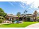Spacious backyard with a pool, grassy area, and palm trees at 2166 E Caroline Ln, Tempe, AZ 85284
