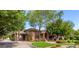 Brick home with a lush lawn and driveway, surrounded by trees at 2166 E Caroline Ln, Tempe, AZ 85284