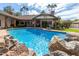 Refreshing blue pool with rock waterfall feature; backyard oasis at 2166 E Caroline Ln, Tempe, AZ 85284