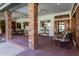Brick-columned covered patio with comfortable seating and tile flooring at 2166 E Caroline Ln, Tempe, AZ 85284
