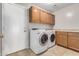 Laundry room with washer, dryer, and cabinets at 1262 E Stirrup Ln, San Tan Valley, AZ 85143