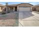 Tan house exterior with a two-car garage and landscaping at 4657 W Carson Rd, Laveen, AZ 85339