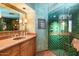 Spa-like bathroom with green tile shower and vanity at 11155 E Honda Bow Rd, Scottsdale, AZ 85262