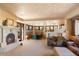 Living room with fireplace, seating area, and access to a patio at 11155 E Honda Bow Rd, Scottsdale, AZ 85262