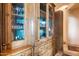 Ornate wooden china cabinet with glass doors and ample storage at 11155 E Honda Bow Rd, Scottsdale, AZ 85262