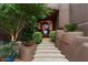 Inviting front entrance with stone steps and lush landscaping at 11155 E Honda Bow Rd, Scottsdale, AZ 85262