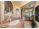 Spa-like bathroom with a large oval tub and artistic wall mural at 11155 E Honda Bow Rd, Scottsdale, AZ 85262