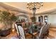 Formal dining room featuring a glass-top table and ornate chandelier at 11155 E Honda Bow Rd, Scottsdale, AZ 85262