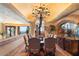 Elegant dining room with a large table, chandelier, and scenic views at 11155 E Honda Bow Rd, Scottsdale, AZ 85262